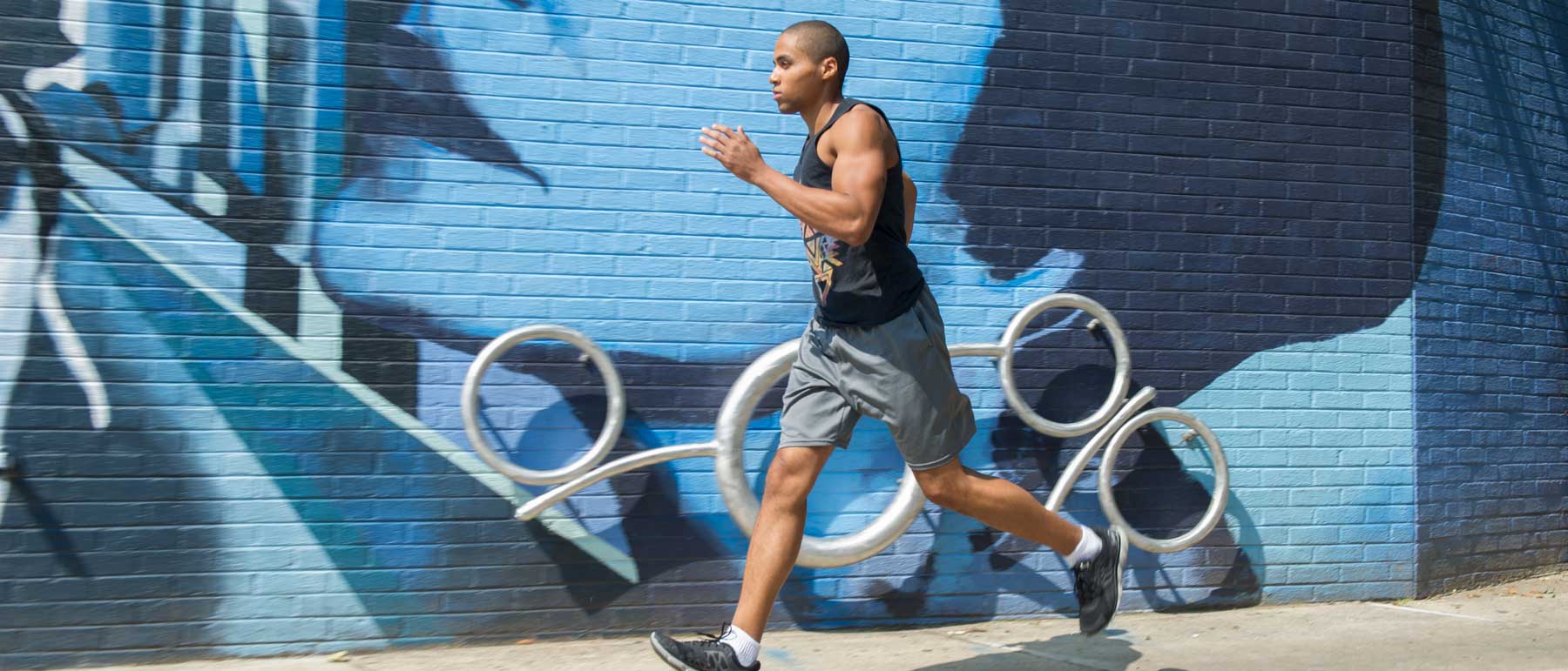 a runner running along a colorful city street